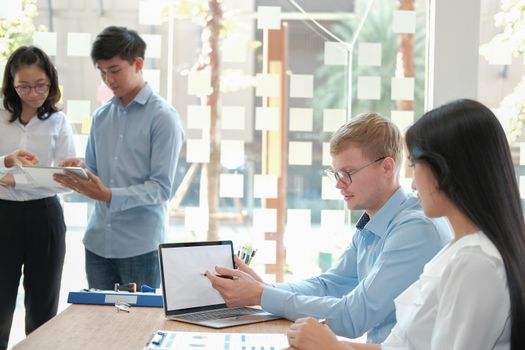 business people discussing on performance revenue in meeting. businessman working with co-worker team. financial adviser analyzing data with investor.