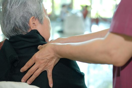 physiotherapist massage old senior woman shoulder