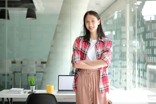 asian teenage girl teenager posing at co-working space