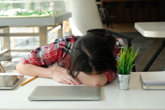 woman sleeping at workplace. girl tired exhausted from hard work