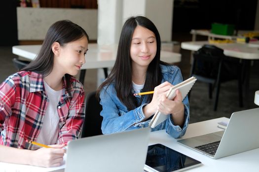 girl teenager studying with computer laptop. college high school student taking note