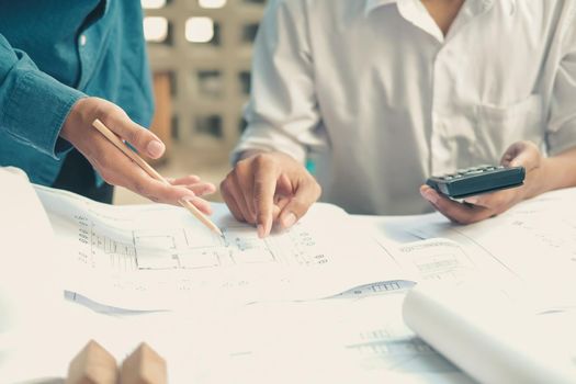 architect engineer working on house blueprint of real estate project at workplace. building construction concept