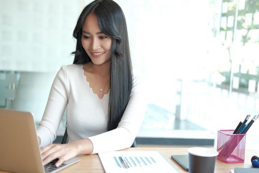 businesswoman freelancer working with computer at office. startup woman entrepreneur analyzing data at workplace. student studying doing assignment