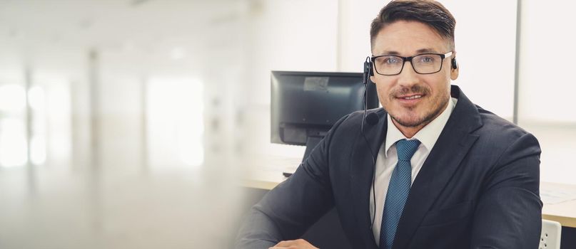 Business people wearing headset working in office to support remote customer or colleague. Call center, telemarketing, customer support agent provide service in broaden view .