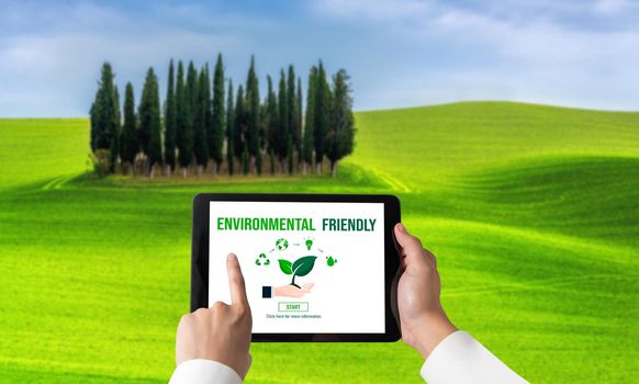 Green business transformation for environment saving and ESG business concept. Businessman using tablet to set corporate goal toward environmental friendly management and alternative clean energy use.