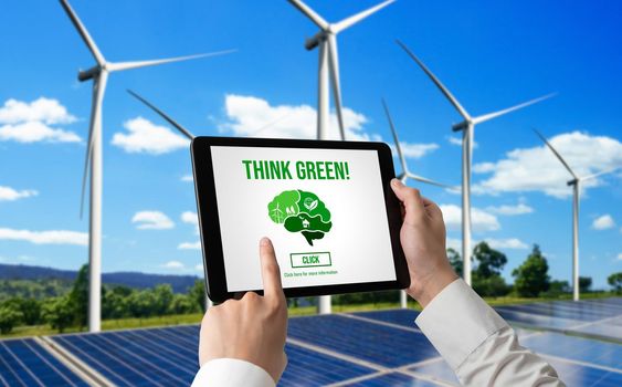 Green business transformation for environment saving and ESG business concept. Businessman using tablet to set corporate goal toward environmental friendly management and alternative clean energy use.