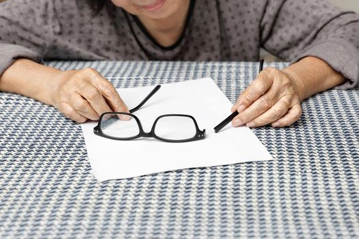 Elderly asian woman repair broken glasses