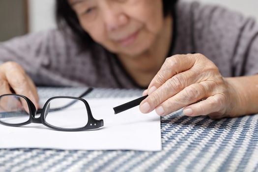 Elderly asian woman repair broken glasses