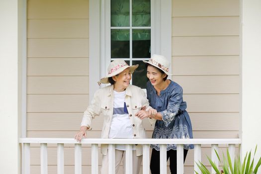 Elderly woman relax in backyard with daughter