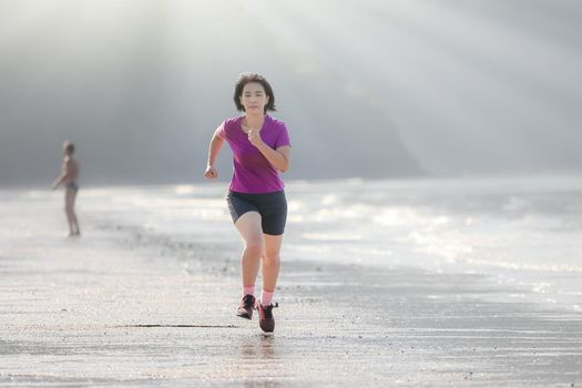 Fitness runner woman on ao nang beach , Krabi , Thailand