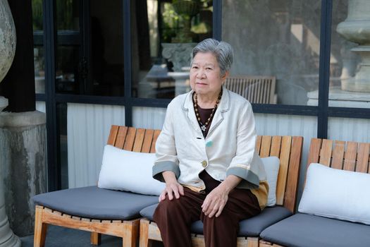 old elderly senior elder woman resting relaxing resting on terrace balcony