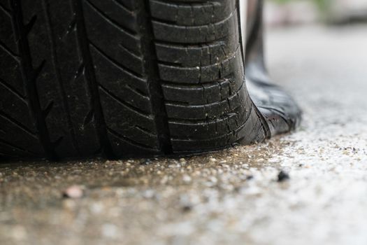 flat tire car in rainy day on stret.