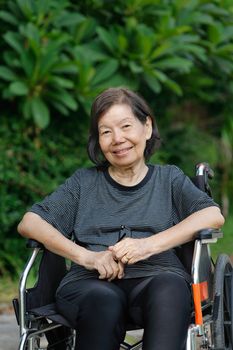 smiling elderly woman ,sitting on wheelchair