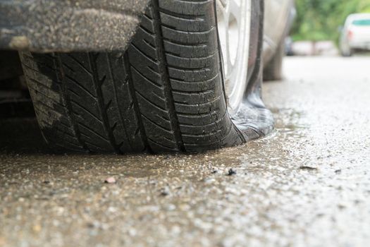 flat tire car in rainy day on stret.