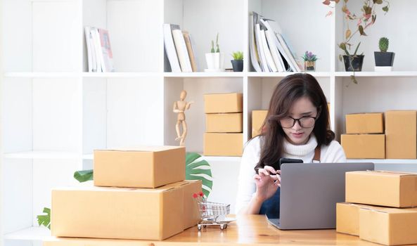 Startup small business entrepreneur SME, asian woman receive order on phone. Portrait young Asian small business owner home office, online sell marketing delivery, SME e-commerce telemarketing concept.