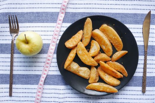 comparing apple and potato wedges, eating heathy food concept