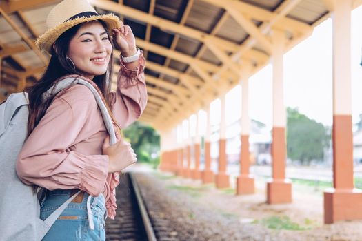 young asian woman  backpacker traveler with backpack at train station. journey trip travel concept