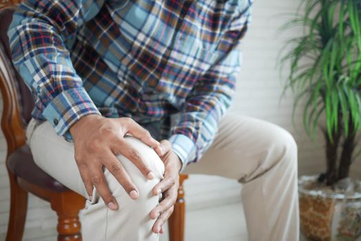 Close up on man suffering knee joint pain.