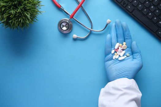 medical pills and capsule on palm of hand , top view .