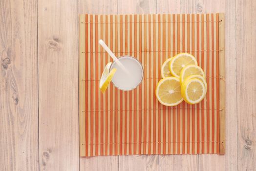Refreshing lemon water drink on table , top view .