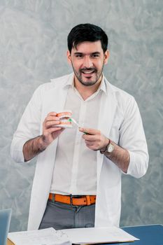 Dentist working with denture in the dental clinic. Dentistry concept.