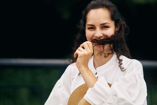 Young beautiful cheerful girl in a summer park. High quality photo