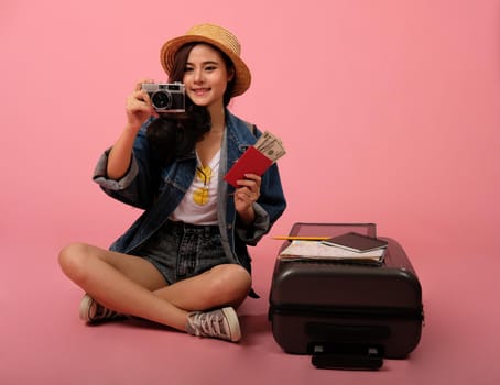 young asian woman backpacker traveler with camera passport. journey trip travel. studio shot