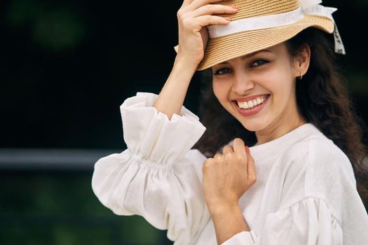 Young beautiful girl in a hat in a summer park. High quality photo