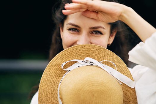 Young beautiful girl in a hat in a summer park. High quality photo