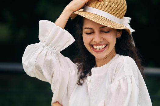 Young beautiful girl in a hat in a summer park. High quality photo