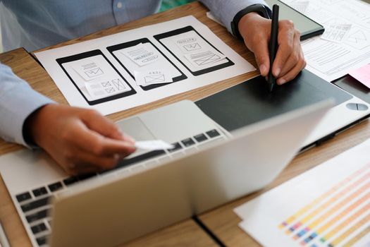 user experience UX designer designing web on smart phone layout. UI planning mobile application. developer work with business prototype