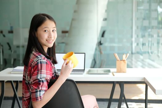 asian teenage girl teenager posing at co-working space