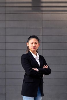 successful asian woman entrepreneur with her arms folded, concept of entrepreneurship and business, copy space for text