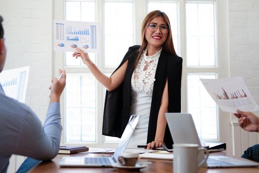 executive businesswoman advising analyzing discussing business project with co-worker team