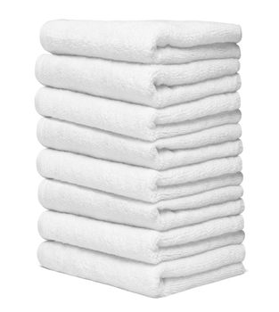 close up of a stack of white towels bathroom on white background