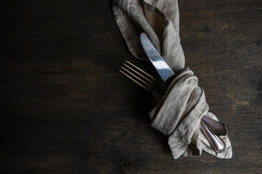 Rustic table setting with vintage cutlery on wooden table