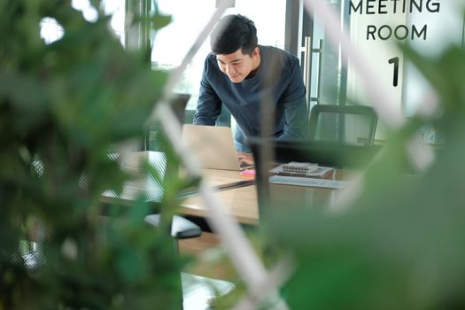 startup male freelancer working with computer at office. man entrepreneur analyzing financial performance at workplace. student studying doing assignment