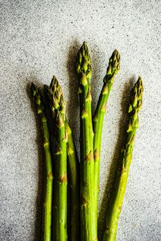 Organic food concept with asparagus on stone table with copy space