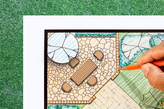 Landscape architect design patio in backyard garden plan.