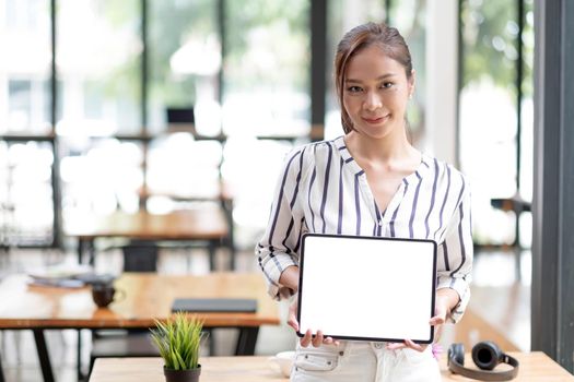 Mockup image of a smiley Asian beautiful woman holding and showing black mobile phone with blank white screen..