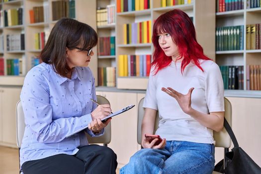 Psychologist, teacher, behavior, college counselor counseling teenage student in library, office. Psychological help, social work, mental health, adolescence, youth psychotherapy psychology concept