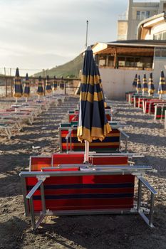 Empty sun beds on the beach during a pandemic coronavirus. Deserted beach in Durres, Albania.