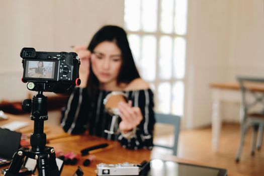 beauty blogger live broadcasting cosmetic makeup tutorial on social media. vlogger recording vlog video. influencer marketing