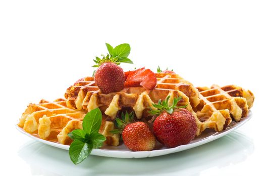 Sweet curd cooked waffles with fresh ripe strawberries, isolated on white background