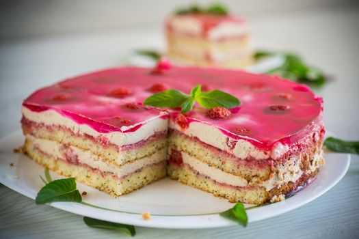 strawberry poppy cake with cream in a plate on a light wooden table