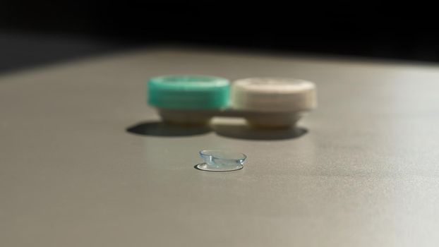 Contact lenses and a storage container on a white table