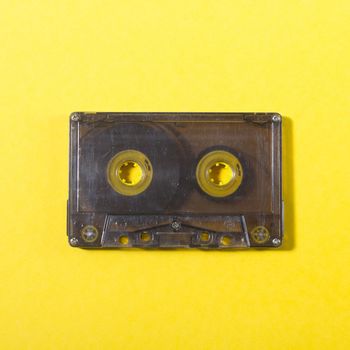 retro audio compact cassette on a yellow background