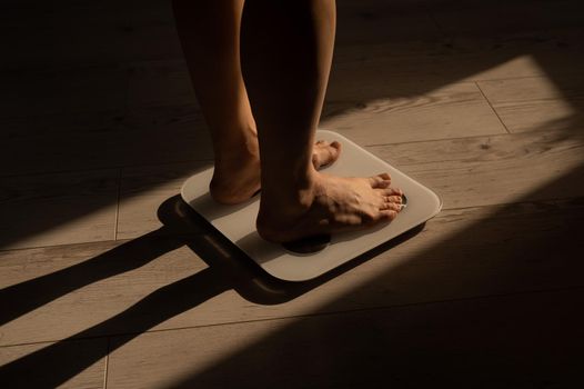 Close-up of female legs on electronic scales