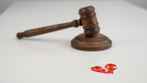 Judicial gavel broken heart and wedding rings