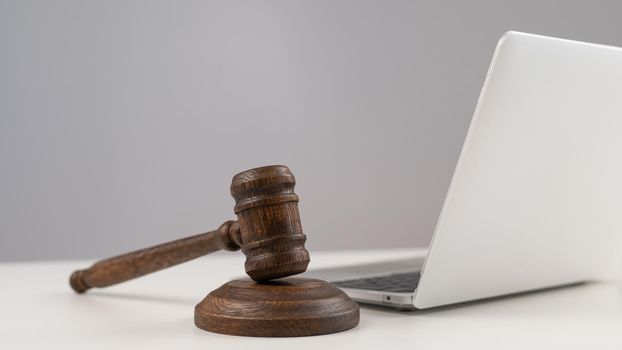 Judicial gavel and laptop on white background